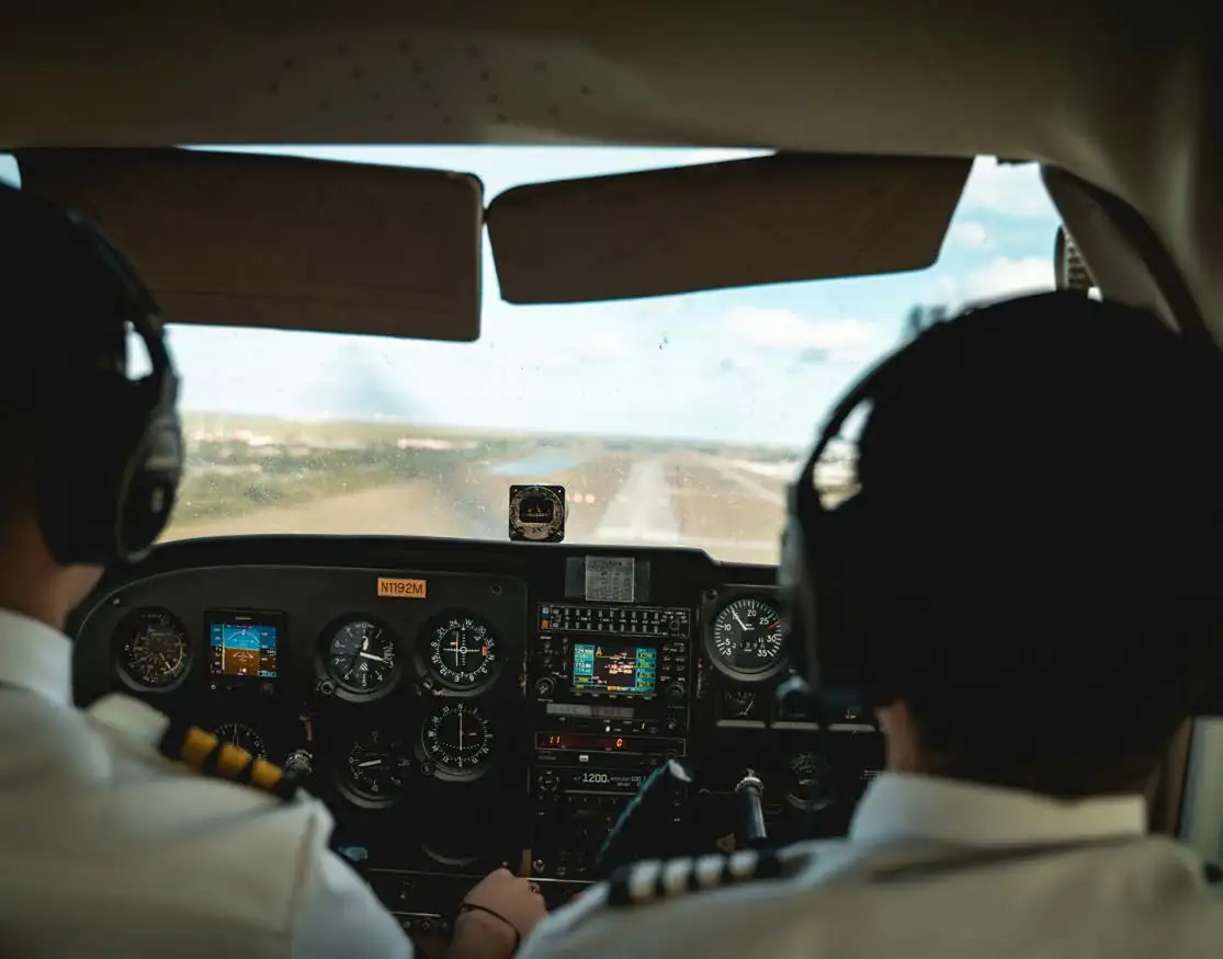 Two pilots in a training airplane cockpit