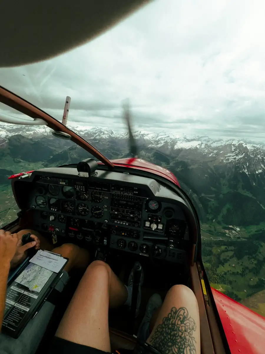 Student pilot's view from the cockpit over mountains