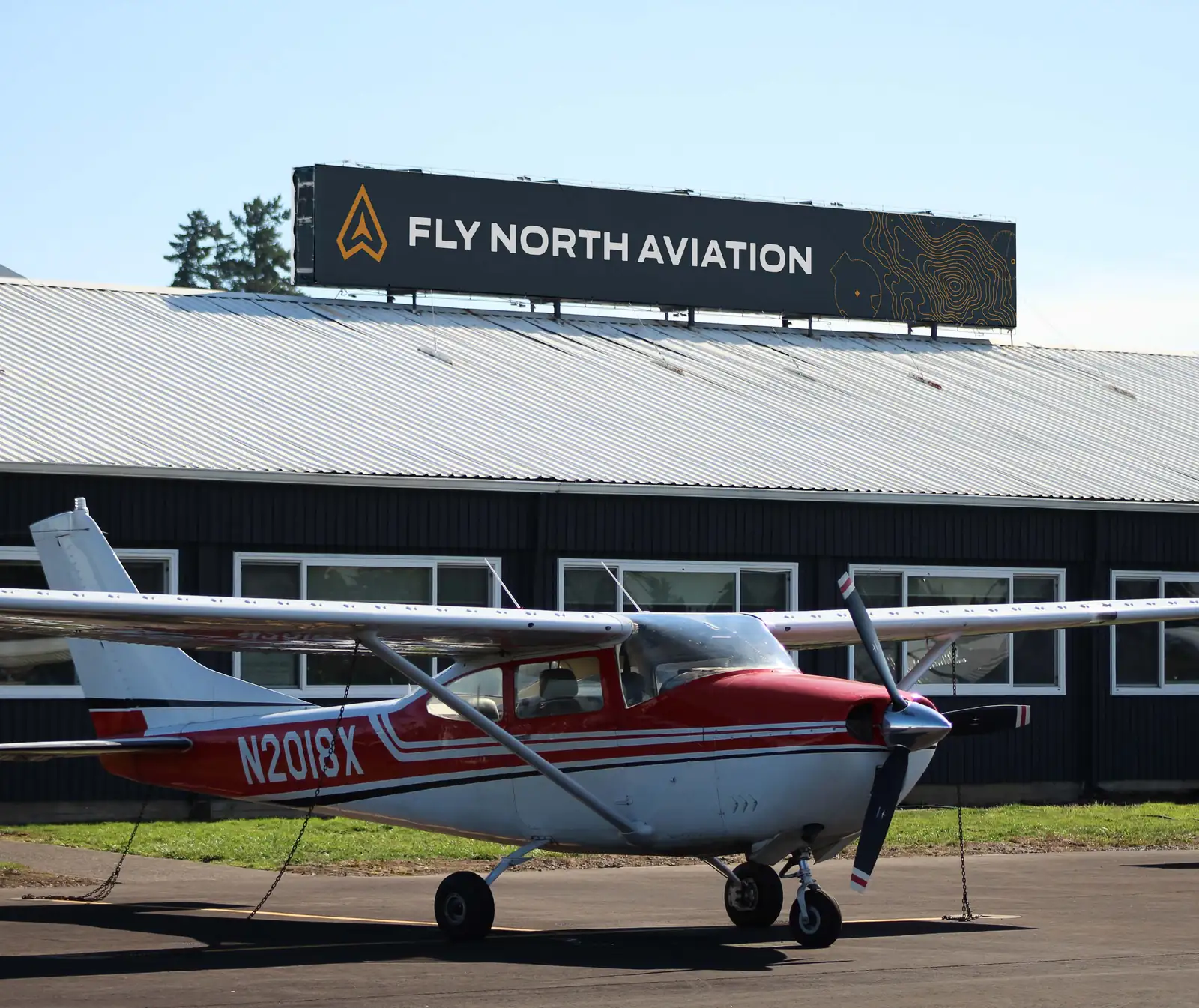 Fly North Aviation hangar with a Cessna on the ramp