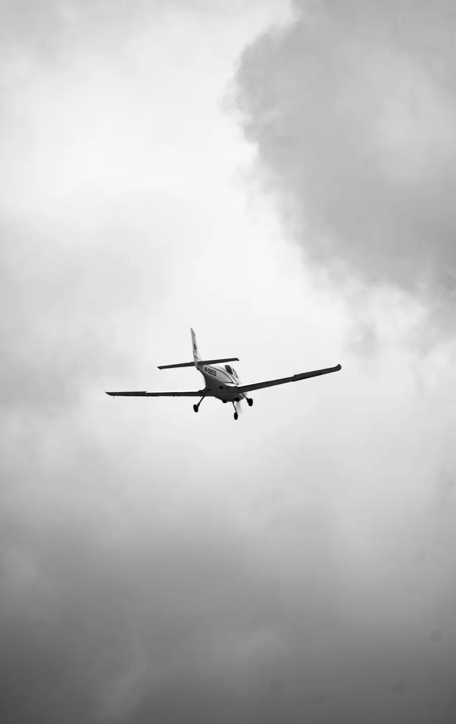 Small airplane flying through clouds